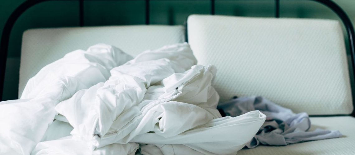 A mattress stripped of bedding before washing cover