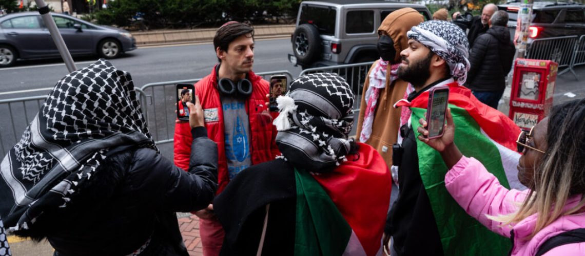 Pro-Palestinian demonstrators surround a Jewish man at a protest outside Columbia University, in Manhattan, April 18, 2024. (Luke Tress)