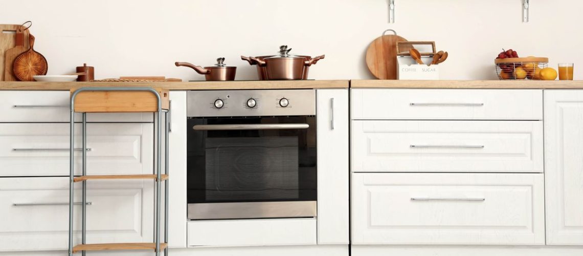 Silver oven in beige colored kitchen