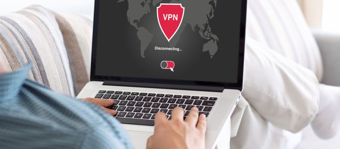 Man holding laptop with VPN app