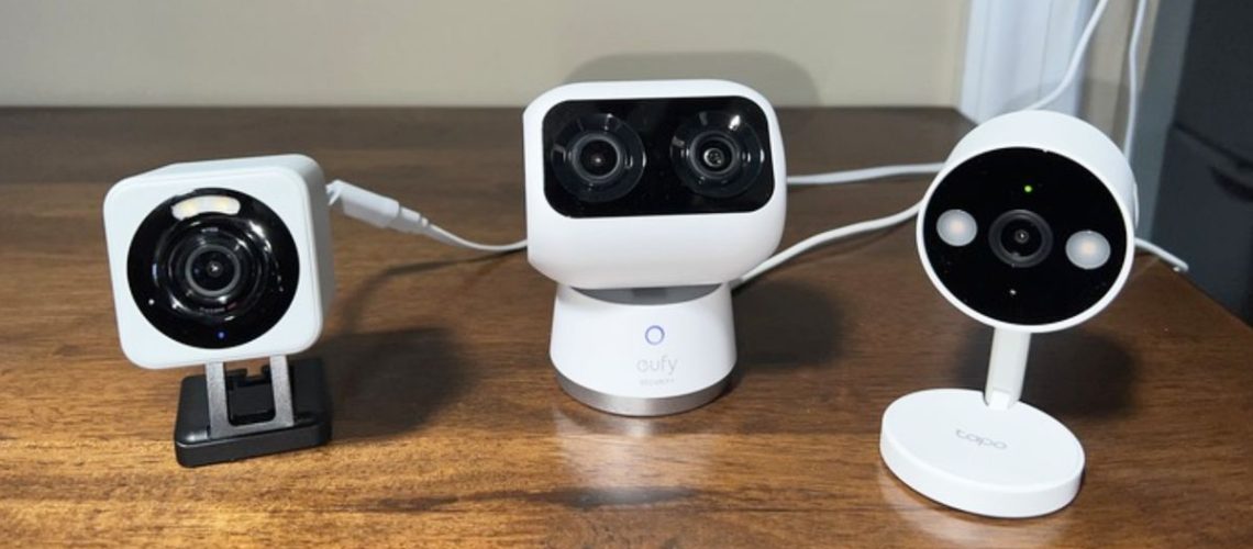 Eufy Tapo and Wyze security cameras lined up on a table