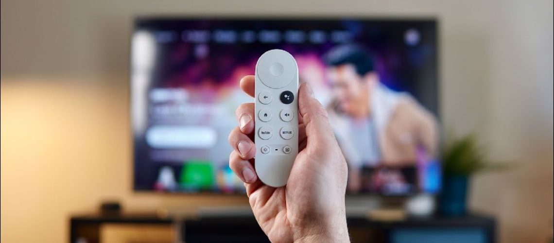 Google TV remote in front of TV