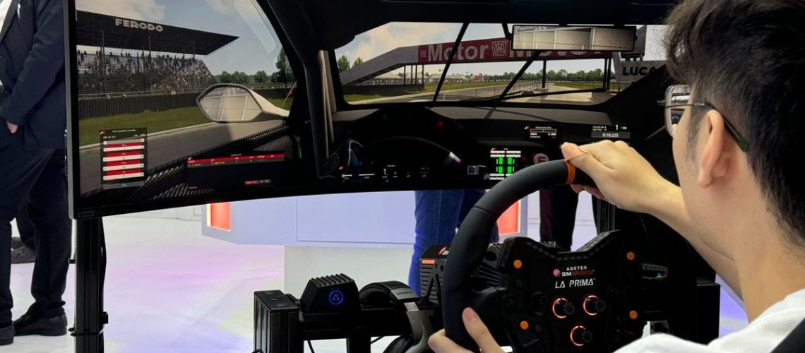 Man playing a racing game on Thermaltake GR500 Racing Sim Cockpit at Computex 2024.