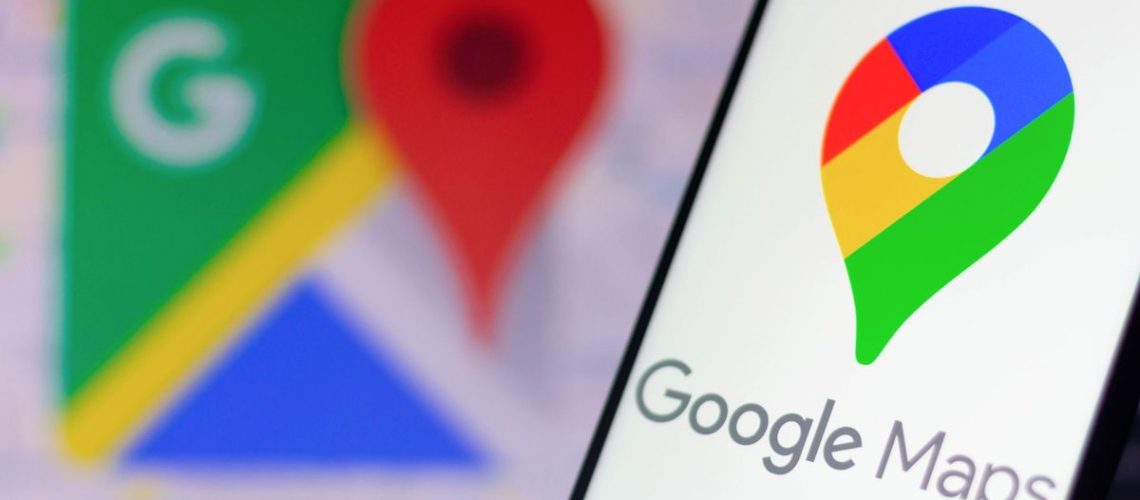 Google Maps logo on smartphone with Google Maps logo in background