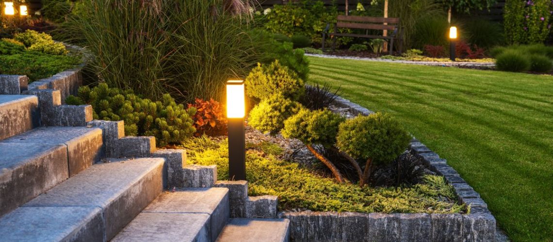 Solar powered light in a manicured garden at dusk