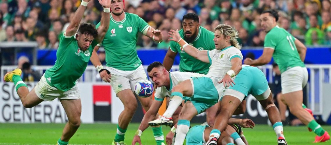 An Ireland rugby player in green (left) runs to block a kick from Faf Dev Klerk during South Africa vs Ireland.