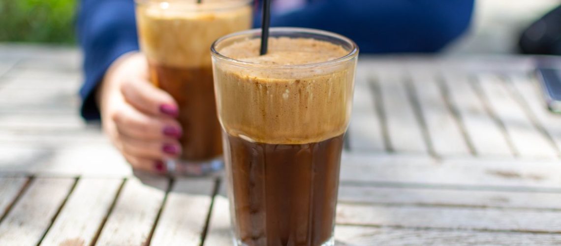 Two glasses of frappe coffee on a table