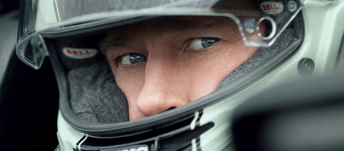 A close-up of Brad Pitt in a racing helmet in Apple