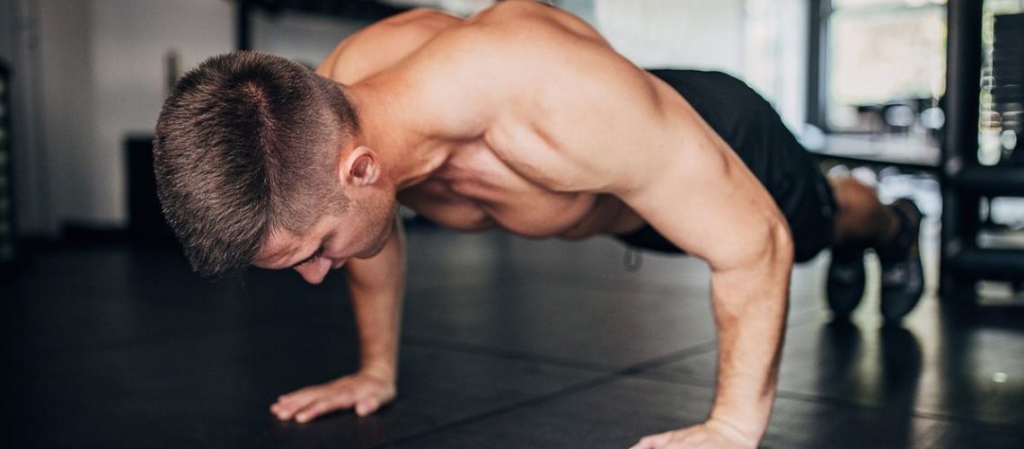 a photo of a man doing a push up