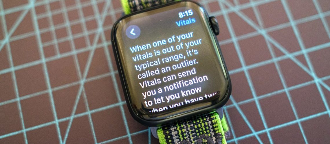 The Apple Watch SE on a green and grey cloth strap showing details from the new Vitals app