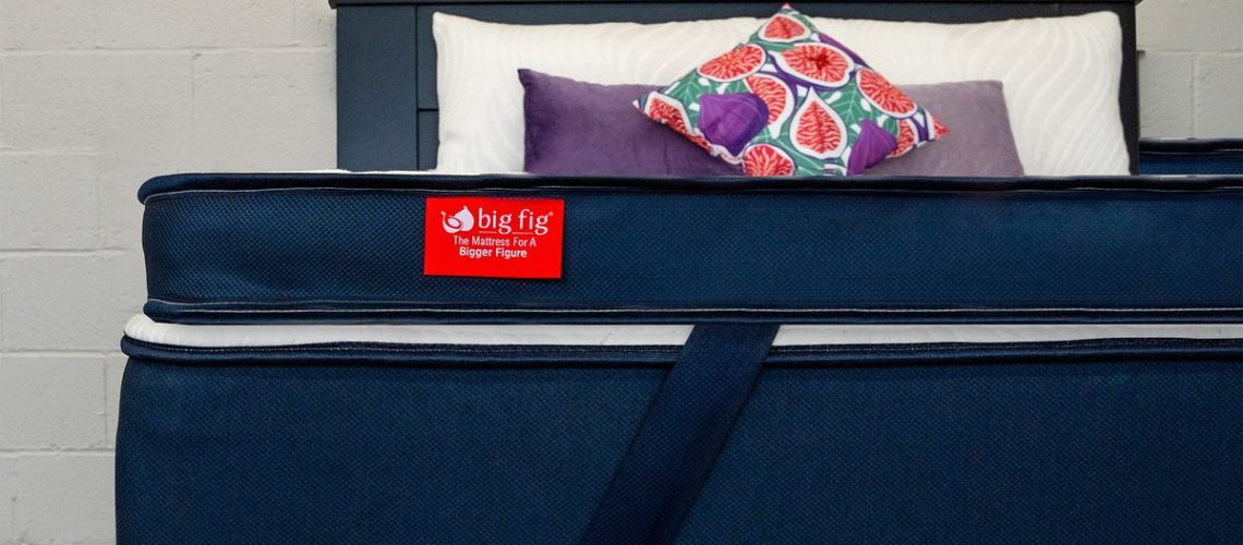 A close up of a Big Fig Premium Plush Micro-Coil Topper on a Big Fig Mattress in a bedroom,