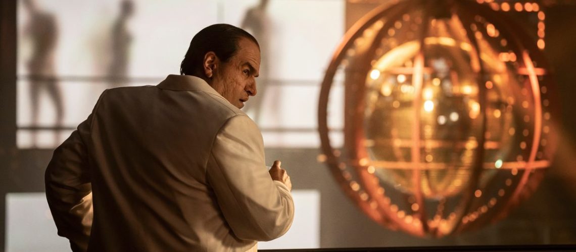 The Penguin (Colin Farrel) looking over his shoulder in a white jacket in the HBO show,