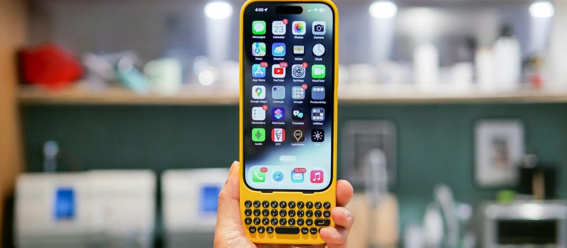 Clicks Keyboard being used with iPhone 15 Pro for typing.