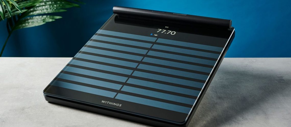 a black tempered glass smart scale with a pull-out ECG monitor showing its sleek modern smart scale finish