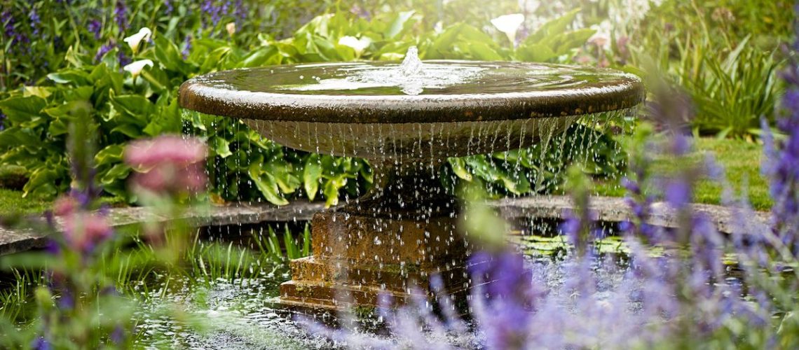 Water fountain in summer garden