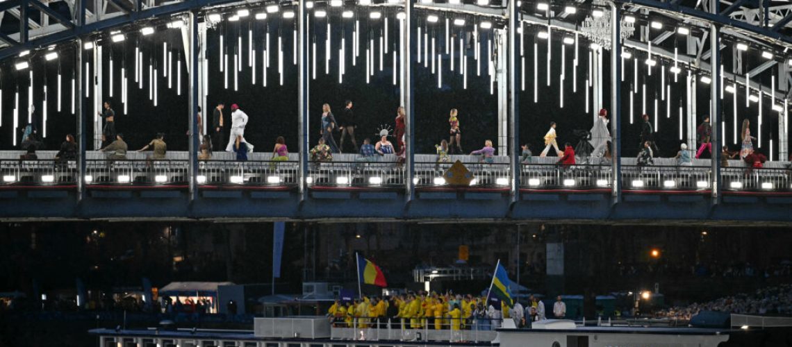 Models walking a catwalk erected along Seine during the opening ceremony.