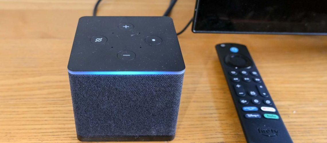 the Fire TV Cube (2022) with blue Alexa bar lit, and remote