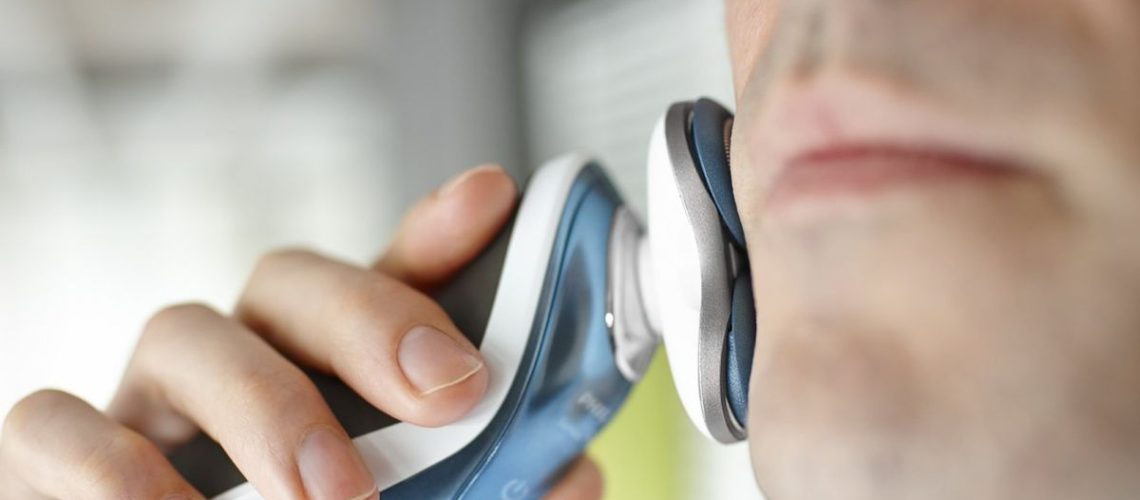 Man shaving with Philips Norelco Electric Shaver 7500