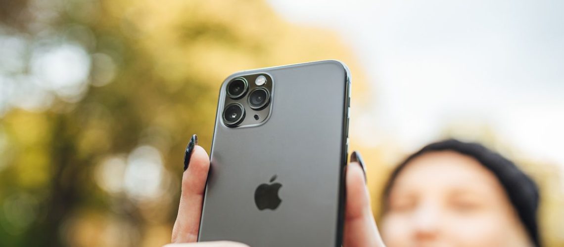 An iPhone being used to take a selfie, demonstrating the hidden iPhone camera feature which mirrors the front camera