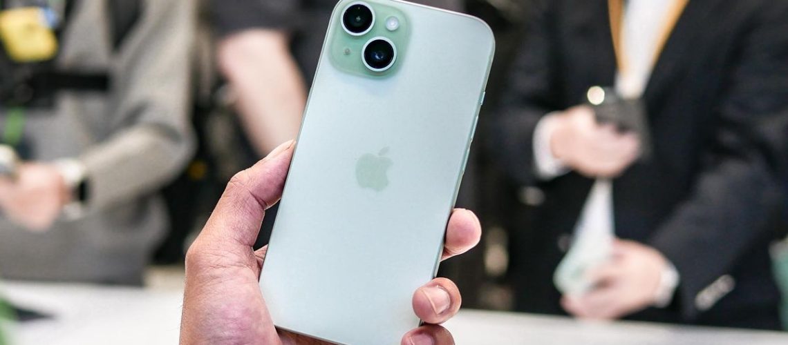 Apple iPhone 15 held in the hand.