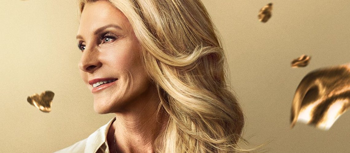 Close up image of blonde mature woman Joan Vassos wearing gold shirt, who is looking to find love again in "The Golden Bachelorette"