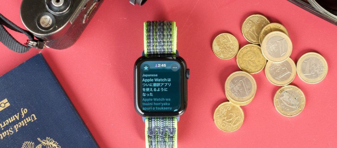 Close-up photo of an Apple Watch SE 2022 against a red background with the new Translate app displayed on the screen