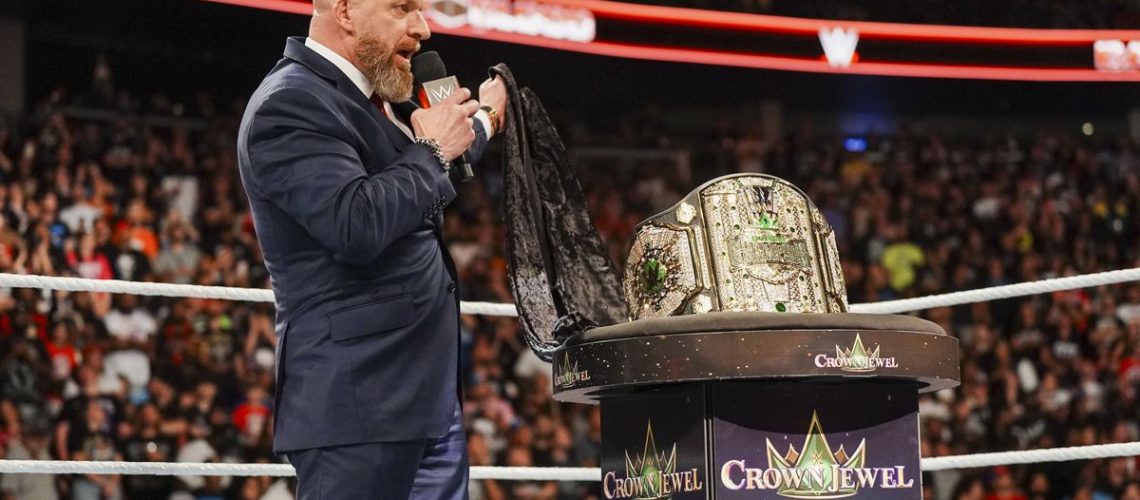 WWE Champion Cody Triple H in a dark blue suit faces presents the Crown Jewel title belt ahead of WWE Crown Jewel 2024