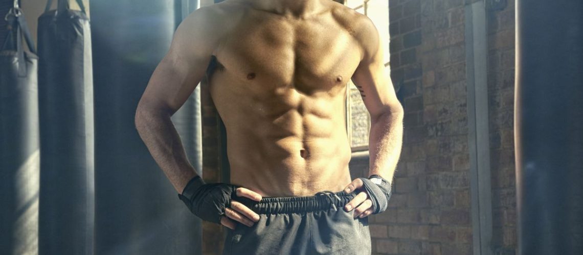 Shirtless man with defined pectoral and abs muscles