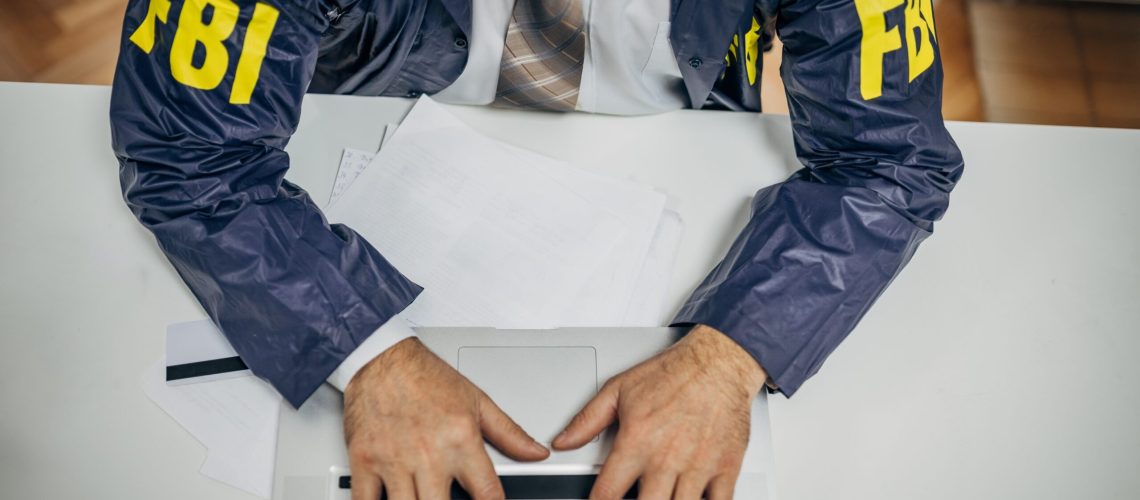 An FBI agent typing on a computer