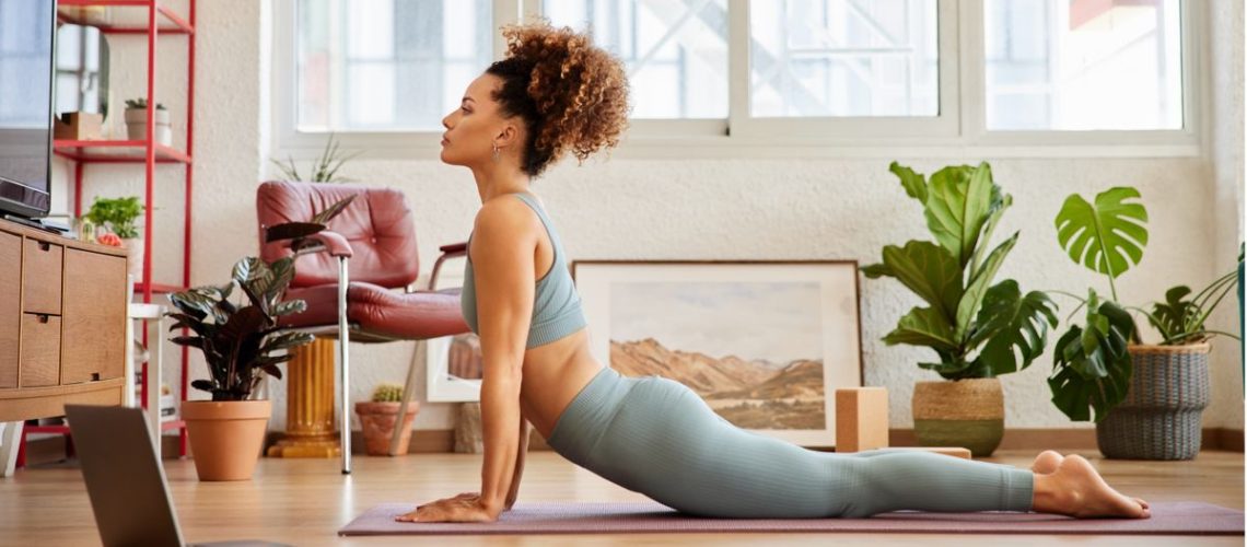 Woman practicing yoga at home