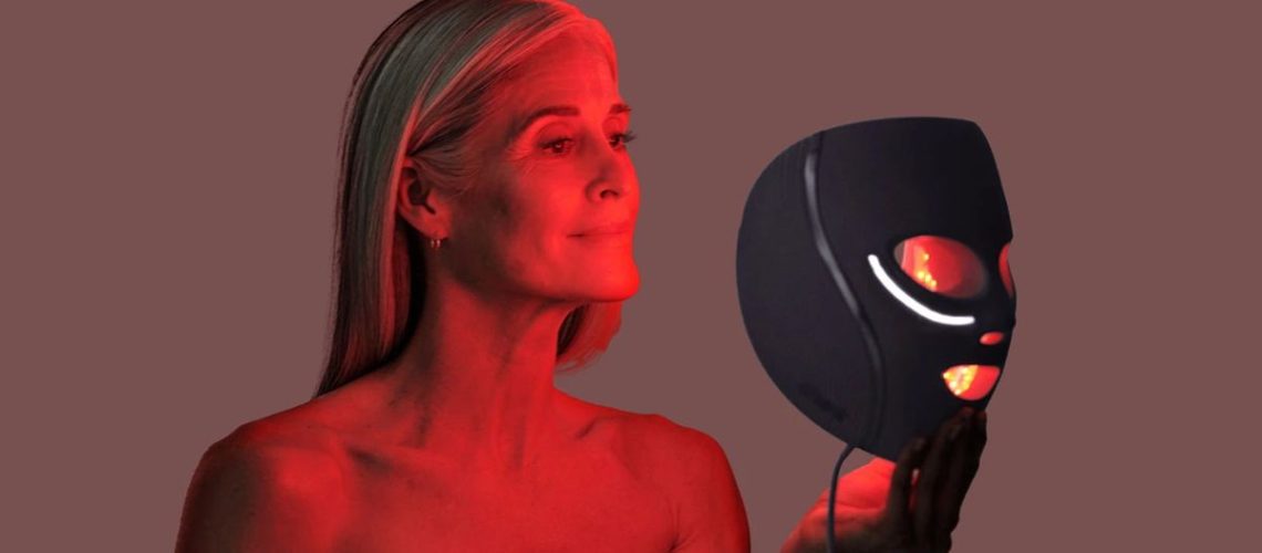 A woman using the Shark CryoGlow lit up in red