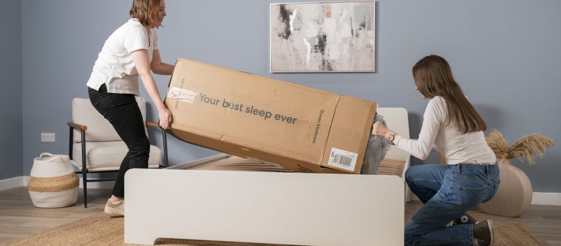 The image shows Tom's Guide's testers unpacking the Siena Memory Foam Mattress