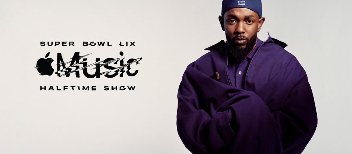 Rapper Kendrick Lamar, wearing a purple jacket and blue cap, poses for the camera in readiness for headlining the Super Bowl 2025 halftime show at New Orleans' Superdome.