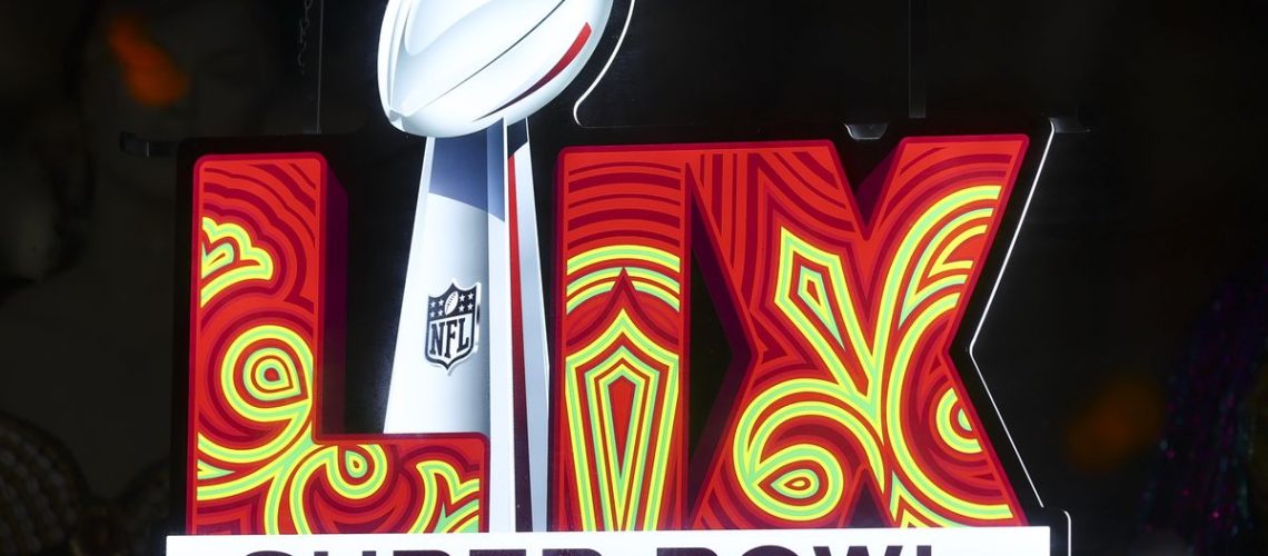 NEW ORLEANS, LOUISIANA - DECEMBER 14: The Super Bowl 59 logo on a brightly lit red and yellow sign in the French Quarter ahead of Super Bowl 2025 today