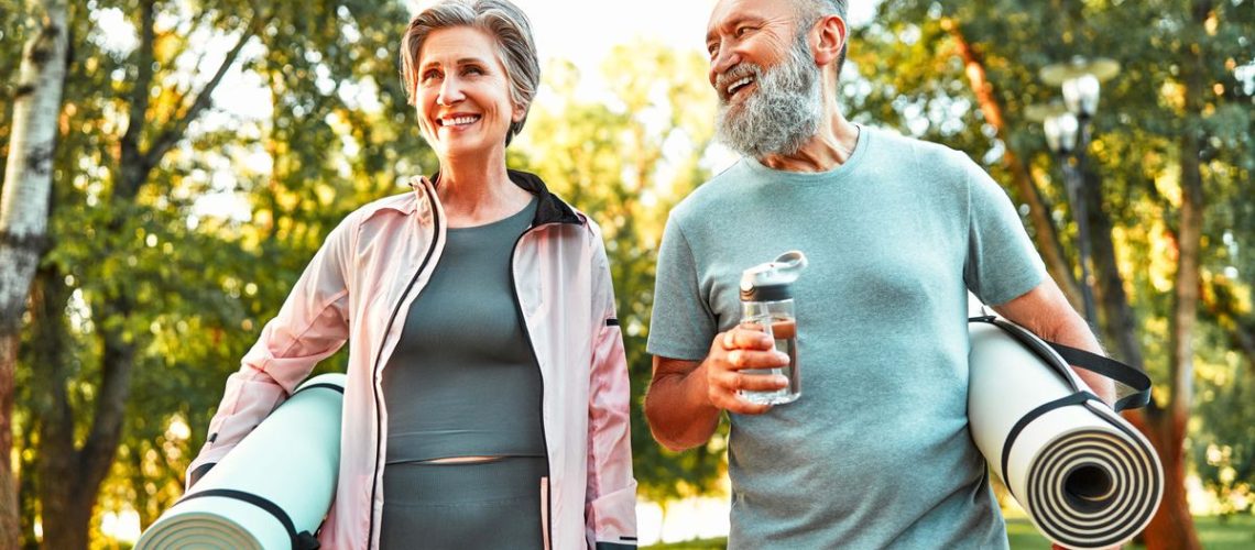 A photo of two older people heading out for exercise