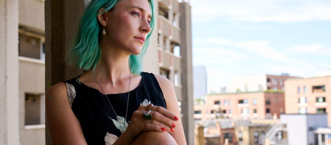 Rona (Saoirse Ronan) leans against a window in "The Outrun"