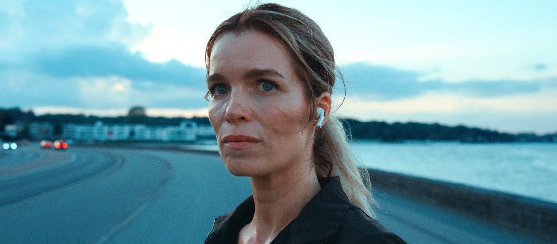 Cecile Vinter-Jensen (Marie Bach Hansen) stands on a sidewalk in Netflix's &quot;Secrets We Keep&quot;