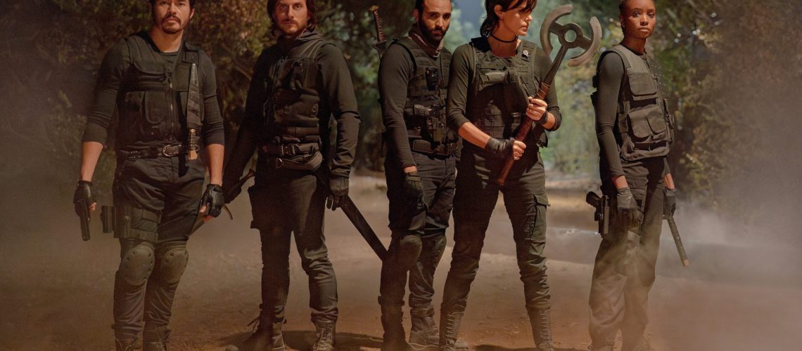 L-R: Tuah (Henry Golding), Nicky (Luca Marinelli), Joe (Marwan Kenzari), Andy (Charlize Theron), and Nile (KiKi Layne) in tactical gear stand ready for battle in Netflix's "The Old Guard 2"