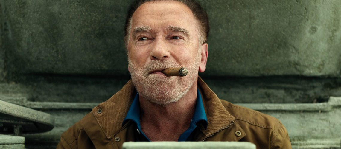 Luke Brunner (Arnold Schwarzenegger) pops out of a tank hatch smoking a cigar in a scene from Netflix's "FUBAR" season 2
