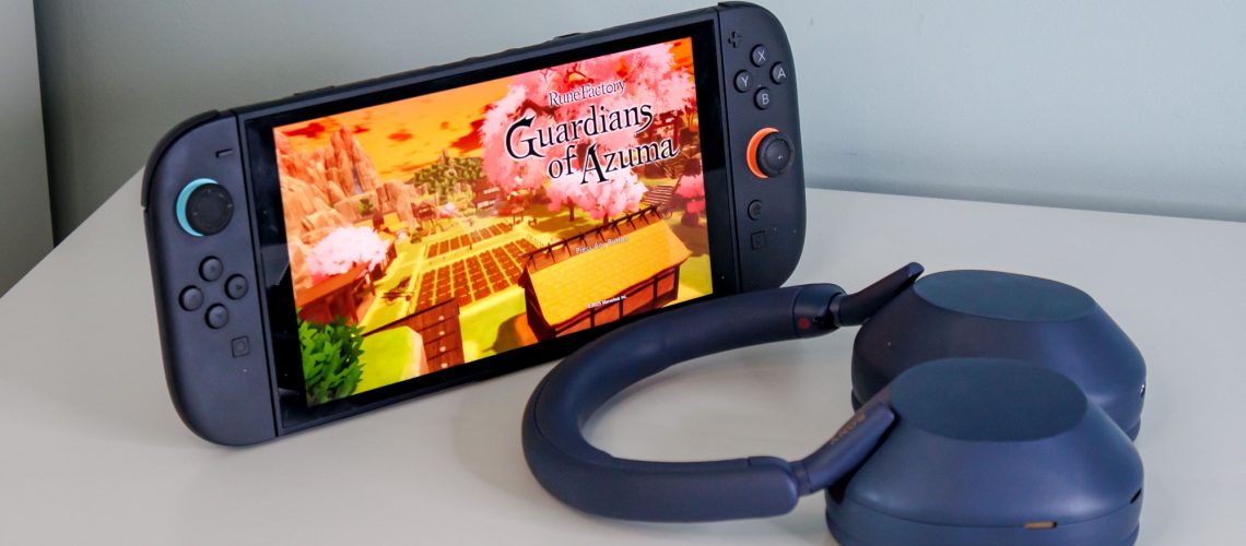 Nintendo Switch and Sony WH-1000XM5 headphones on a white surface