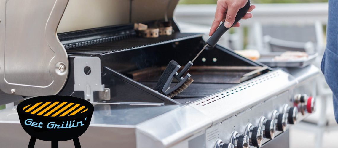 Man cleaning a grill with a brush