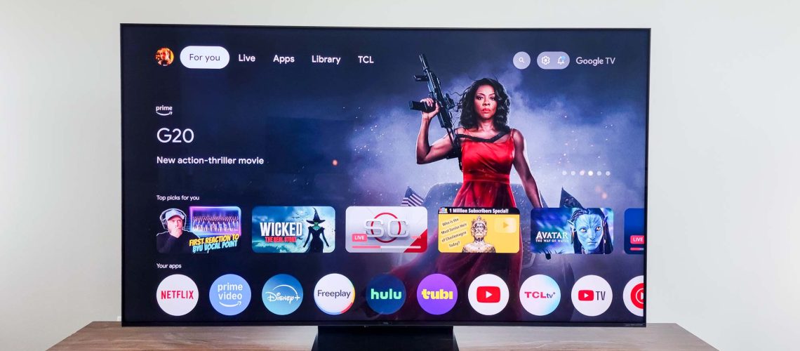 A TCL QM7K QD-Mini LED TV on a side table