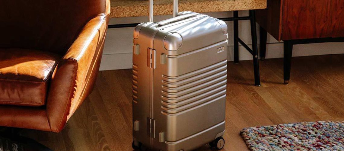 Arlo Skye The Frame Carry-On Luggage on a hardwood floor