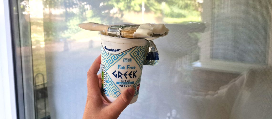 spreading yogurt on a window