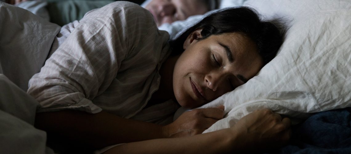 A couple falling asleep in bed