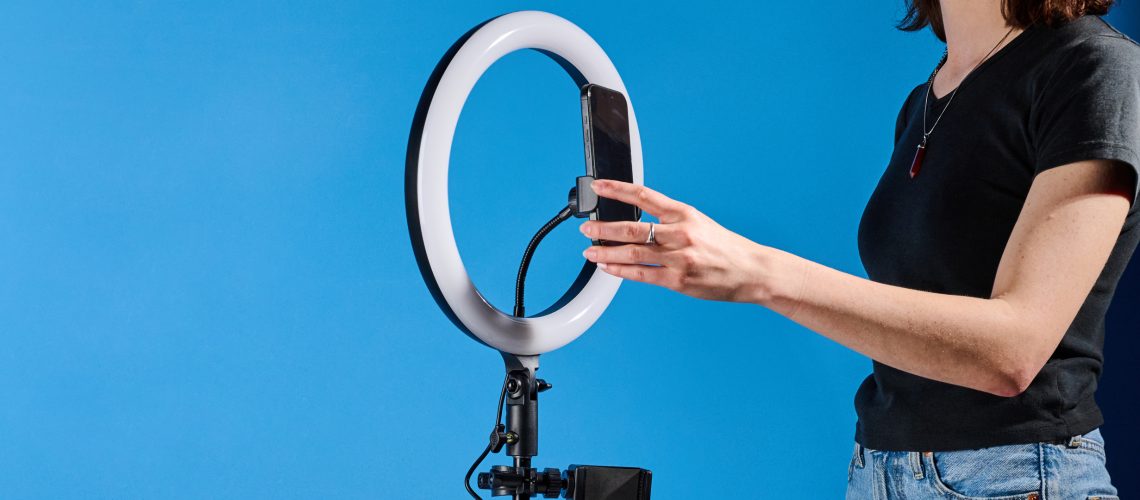 Godox 12-inch ring light photographed in front of a blue background with an iPhone on the phone mount.