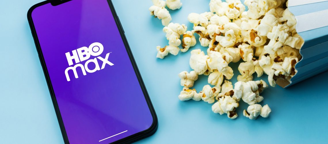 HBO Max logo on phone next to popcorn