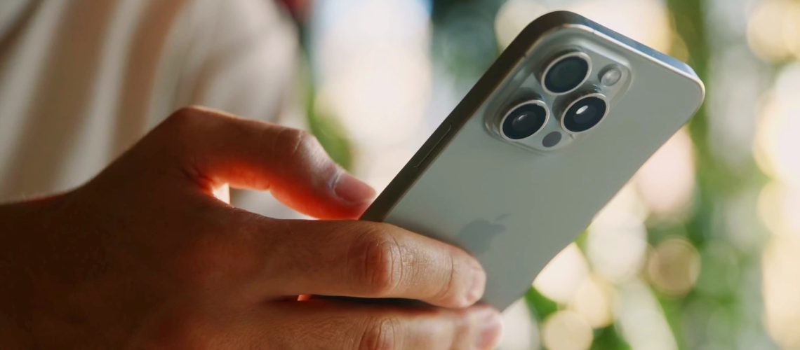 A man typing on an iPhone