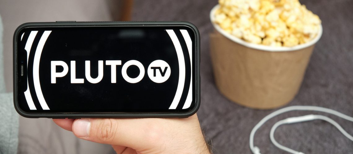 Pluto TV on a phone with popcorn nearby
