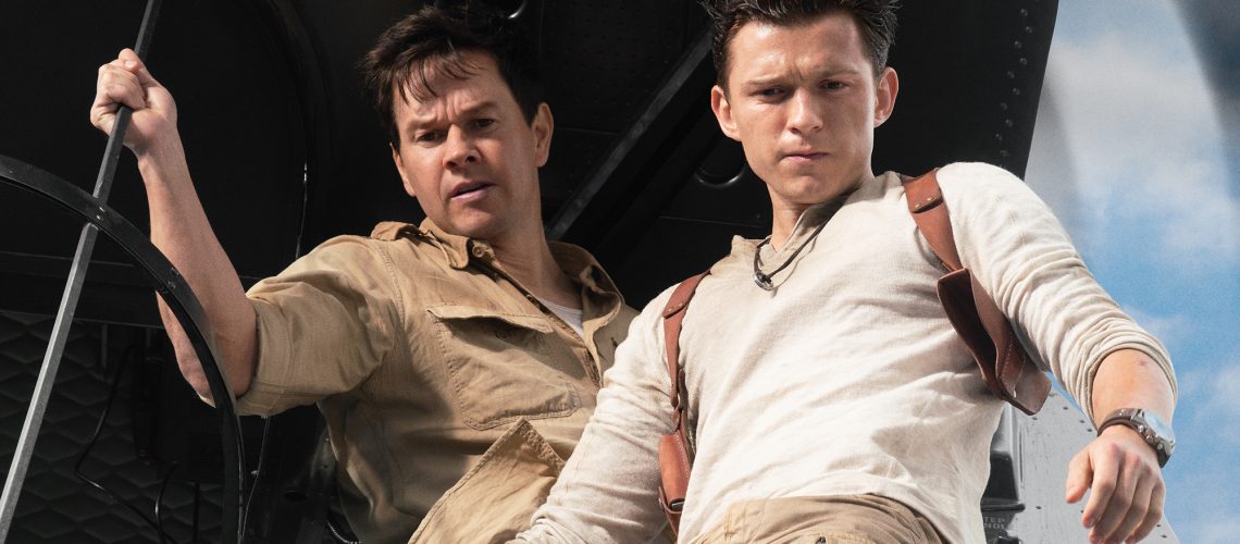 Mark Wahlberg stars as Victor “Sully” Sullivan and Tom Holland is Nathan Drake — both seen staring out of a helicopter —in Columbia Pictures' UNCHARTED
